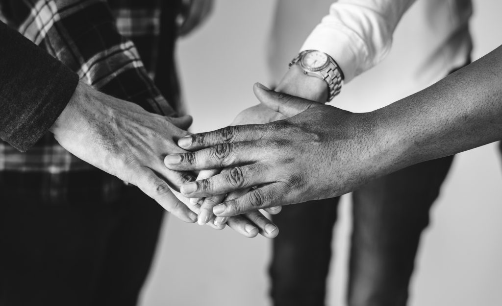 diverse people joining hands together teamwork and community con
